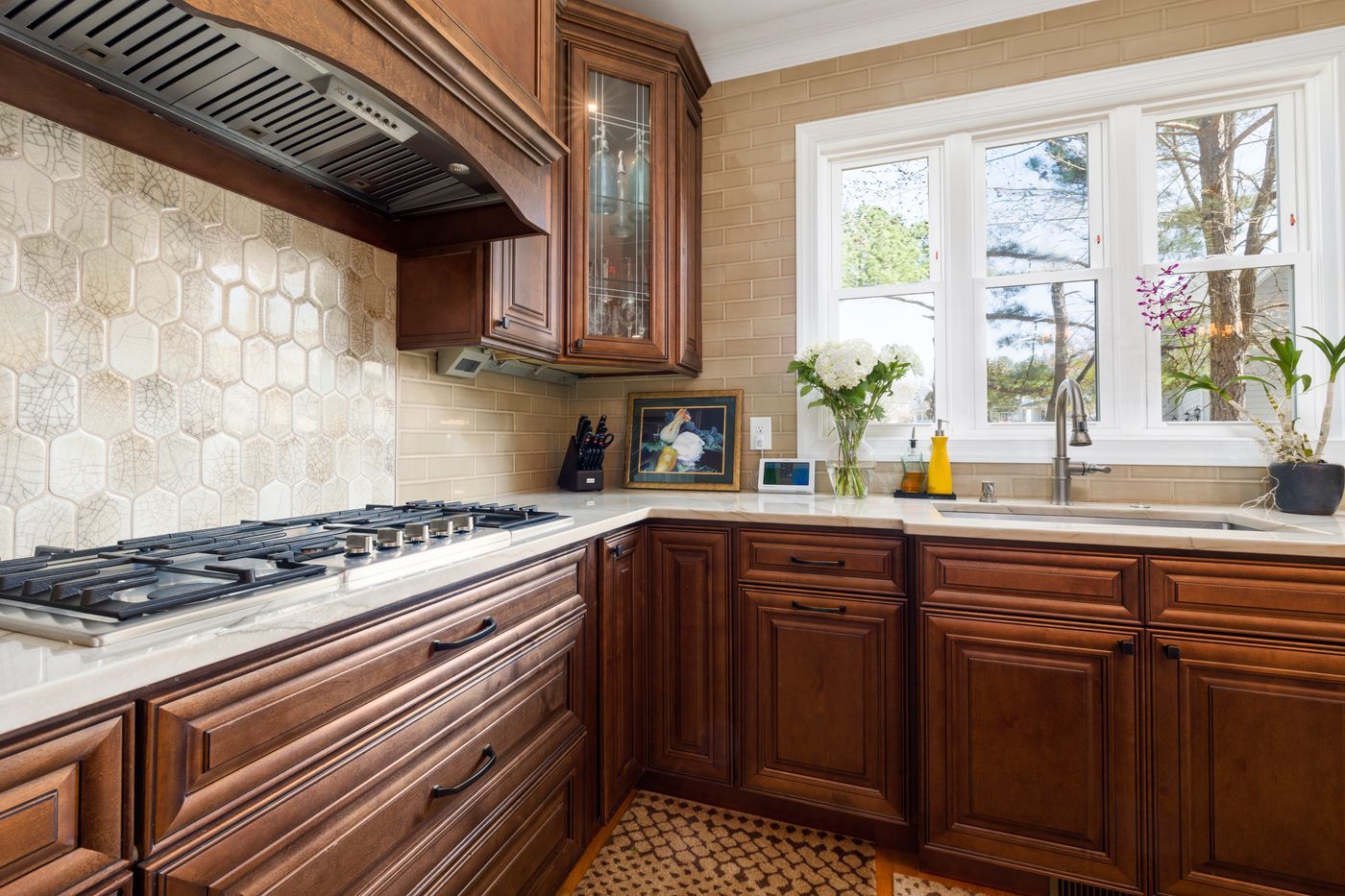 Kitchen with wood cabinets, a tile backsplash, and a gas cooktop