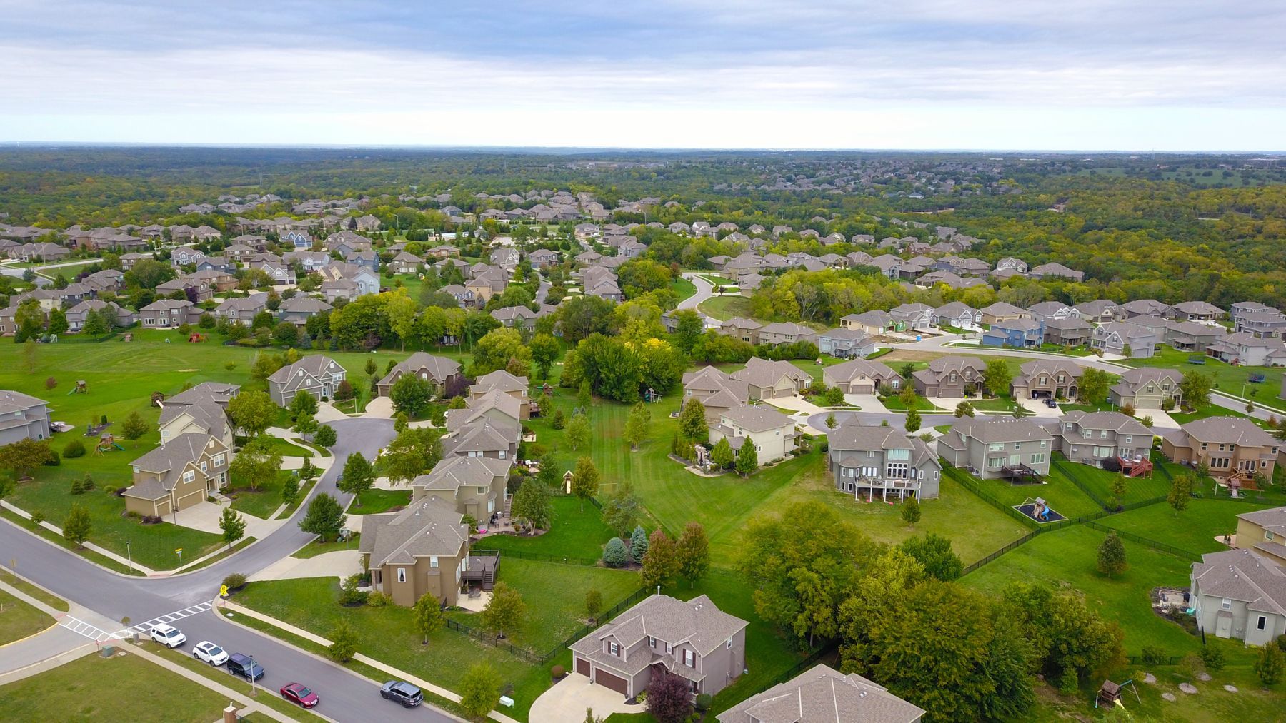 Aerial view of a master-planned subdivision with shingle roofs