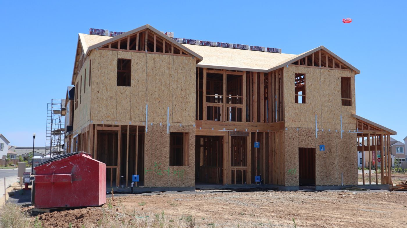 Two-story house being rebuilt in wood framing and sheathing