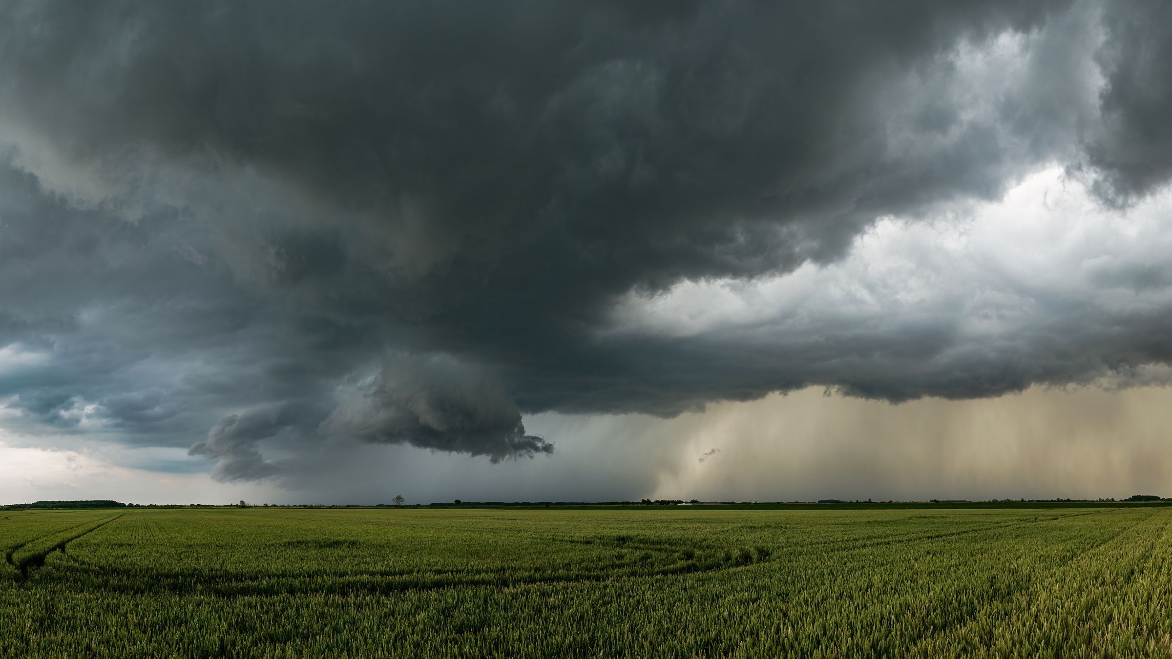 A storm cell over a flat green field