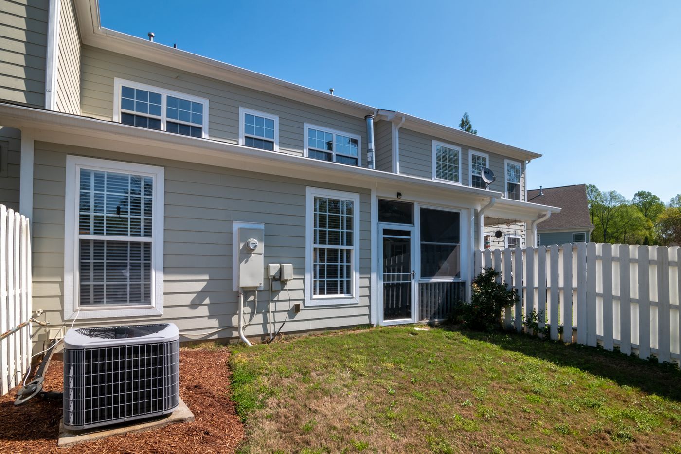 White double-hung windows on a gray siding house